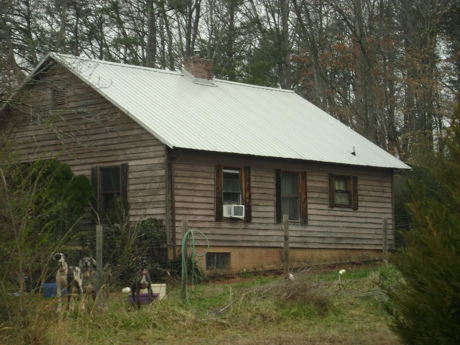 White metal roof on an old wood sided farmhouse, from a Metal Roof Installation job in Port Republic